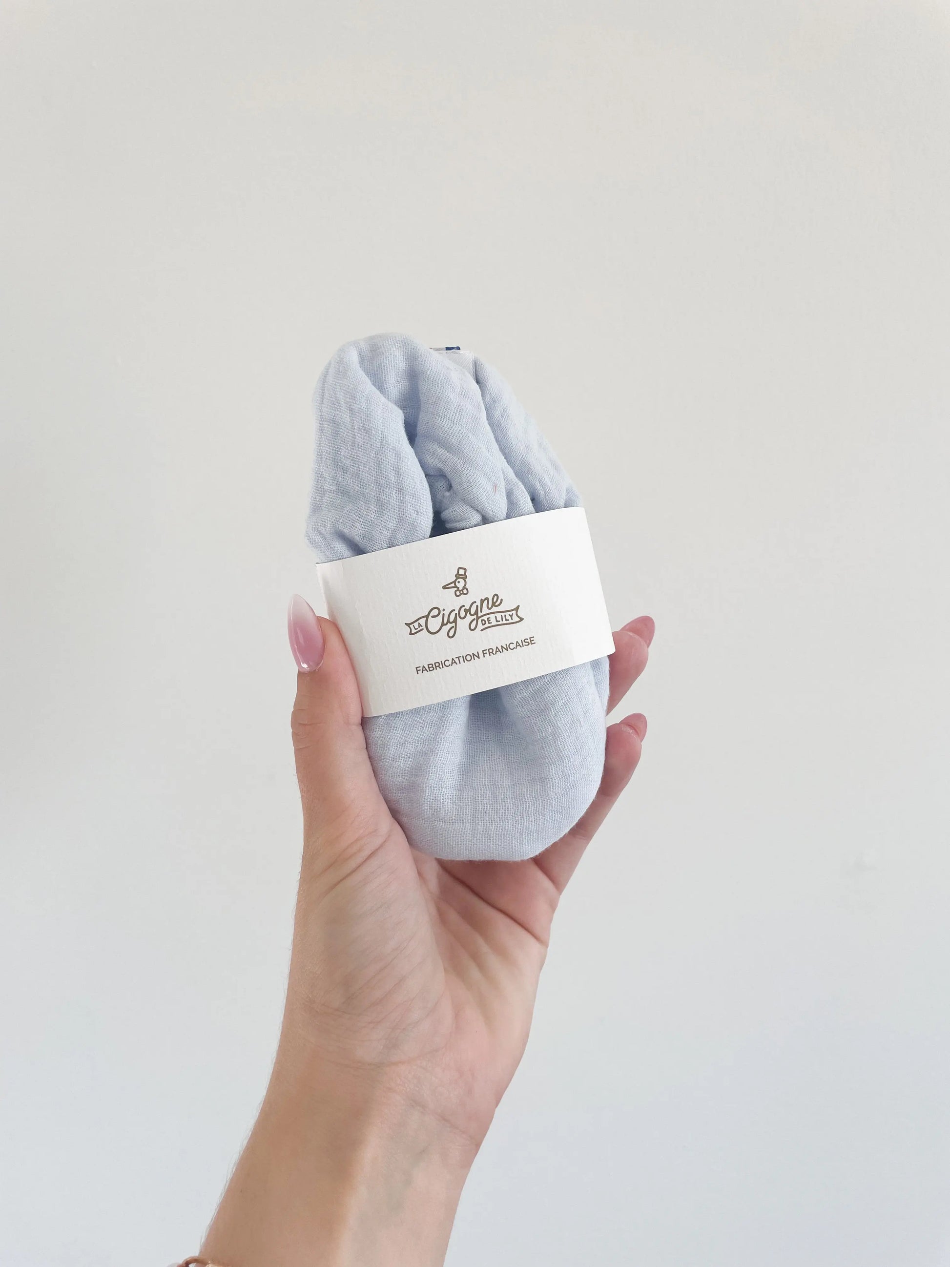 Chaussons Artic pour bébé, vue du dessus mettant en valeur la matière souple et le packaging little cigogne
